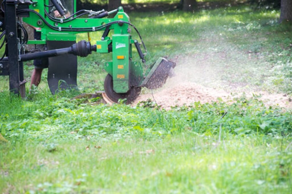 Professional stump grinding machine removing a tree stump below ground level during stump grinding and removal service in Arnold, MO.